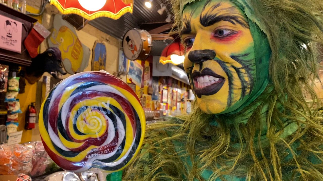 The Grinch staring at a lollipop